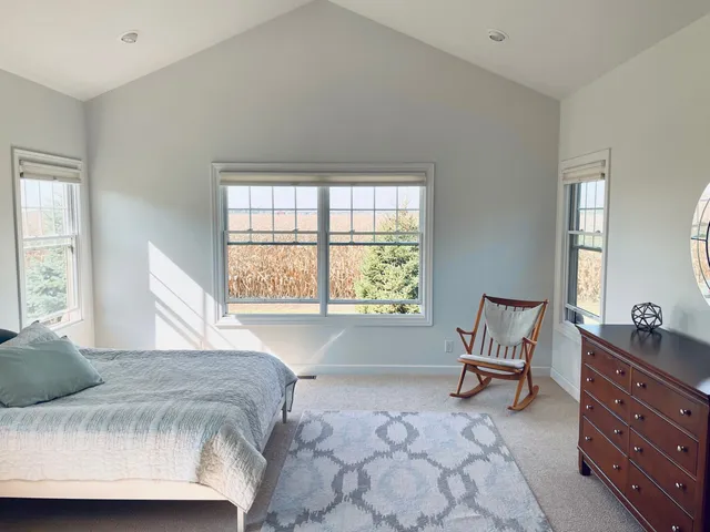 a spacious bedroom with a bed and a window