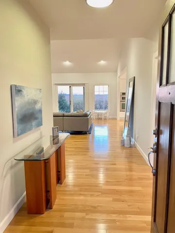 a view of living room filled with furniture and wooden floor