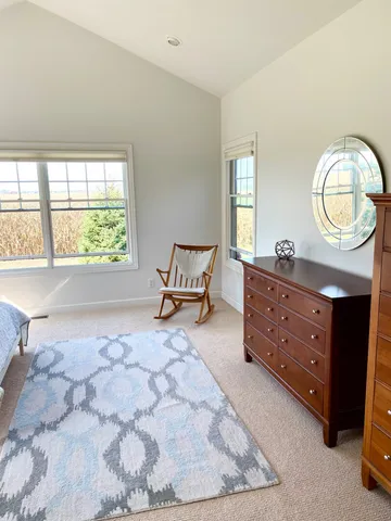 a spacious bedroom with a bed and window