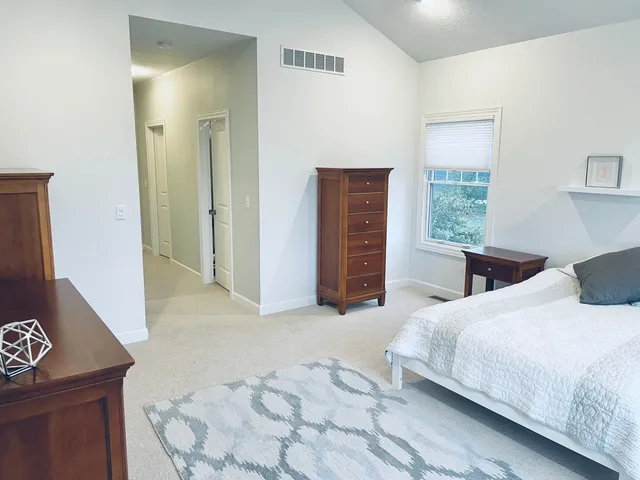 a bedroom with a bed and a dresser