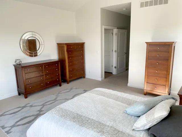 a bedroom with a bed and cabinets