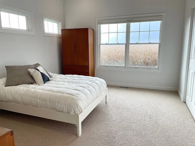 a bedroom with a bed and window