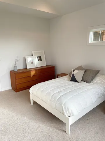 a bedroom with bed and window