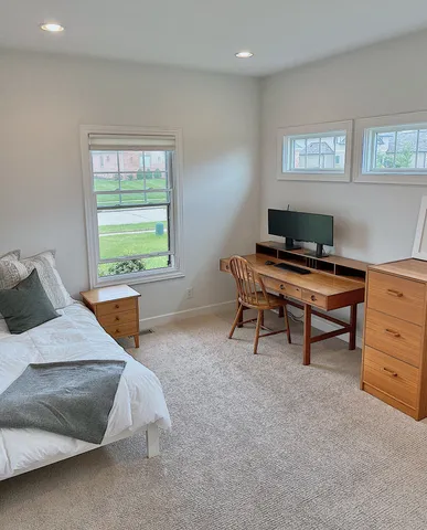 a bedroom with a bed and a desk