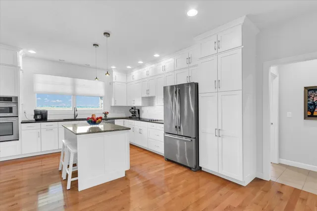 a kitchen with stainless steel appliances a refrigerator sink and cabinets