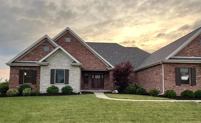 a front view of a house with a yard and garage