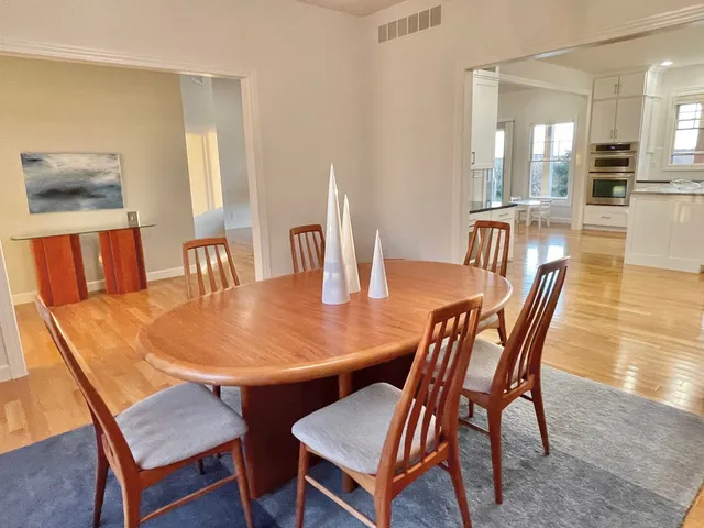 a dining room with furniture and wooden floor