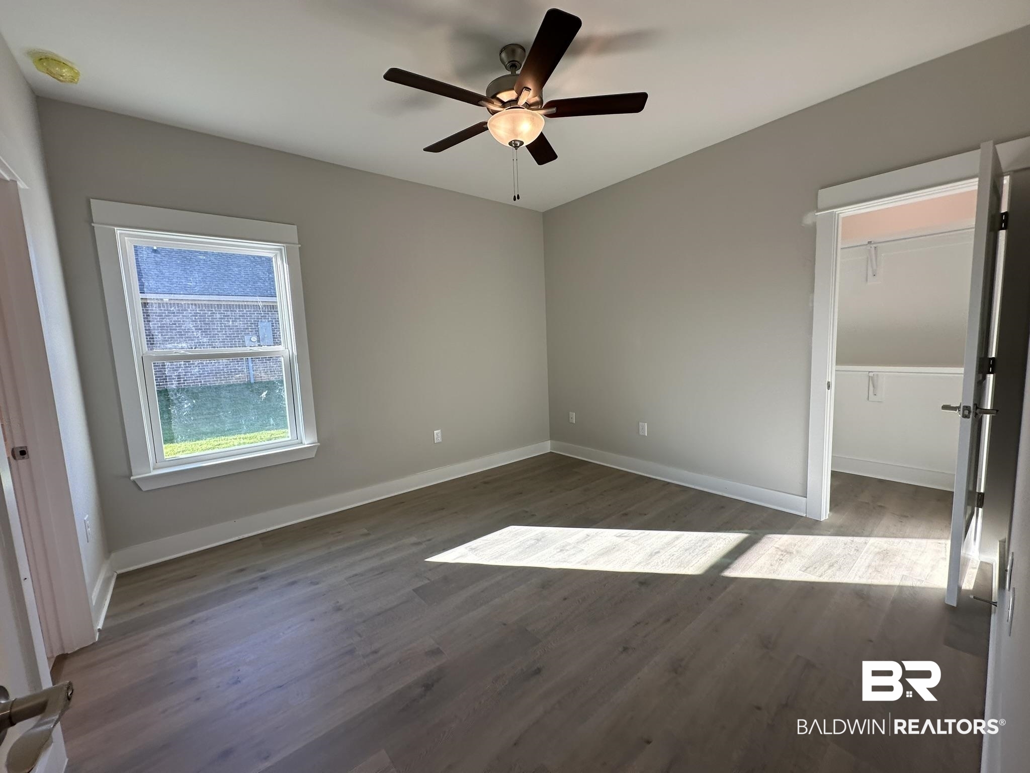 23582 Travis Stock Street, Unit 48 Foley, AL 36535 - Photo 19 of 51 Unfurnished bedroom with ceiling fan and dark hardwood / wood-style floors