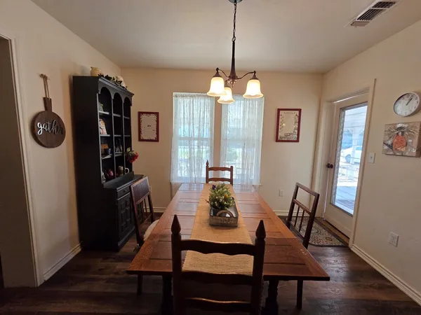 a view of a room with wooden floor