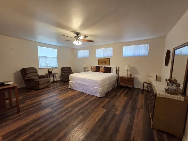 a bedroom with a bed and wooden floor