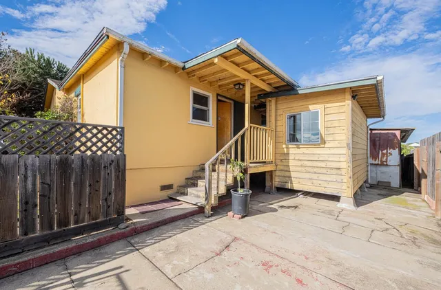 a view of a house with wooden fence