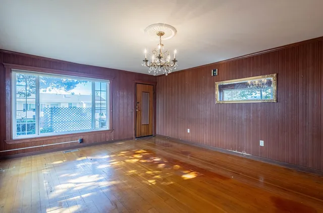 en empty room with windows and entrance