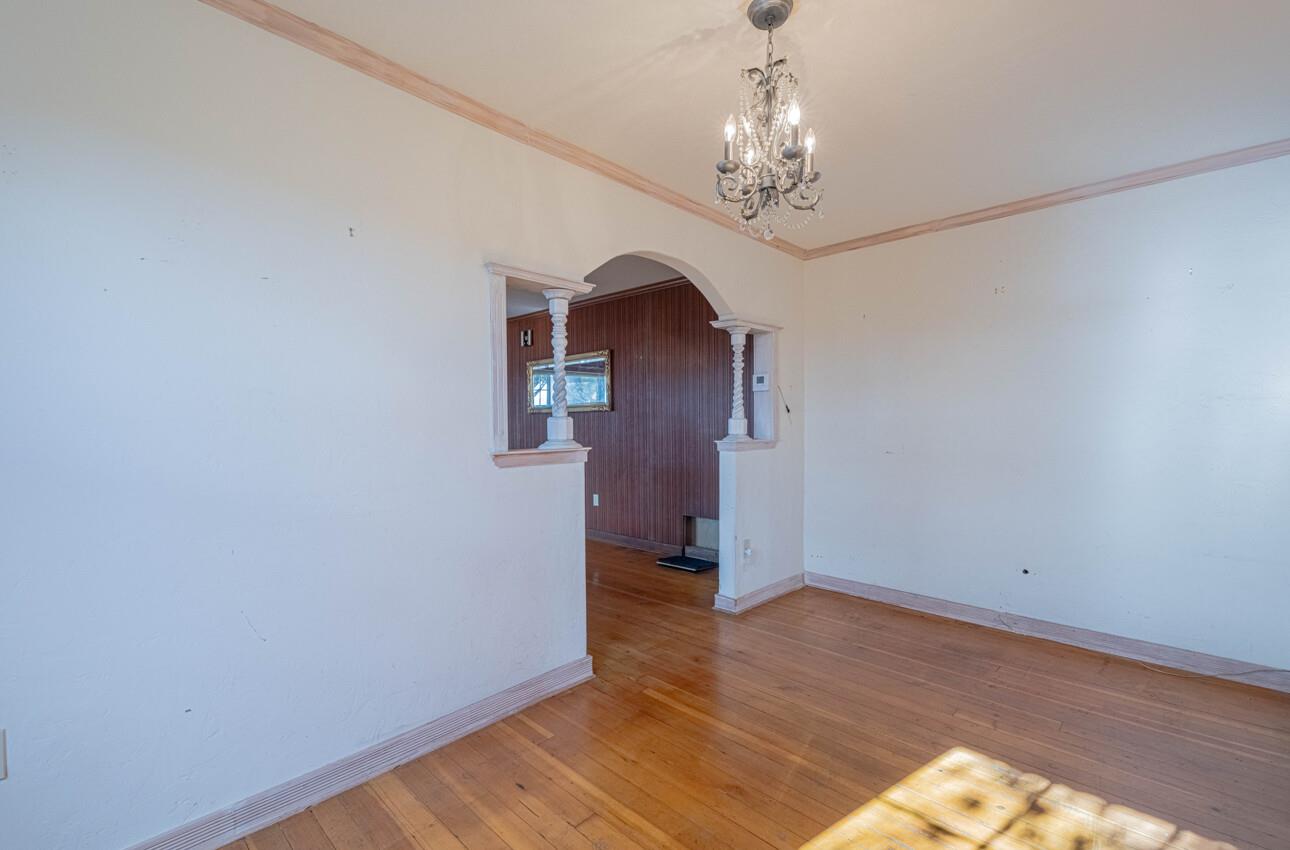 1800 Luxton Street Seaside, CA 93955 - Photo 10 of 48 a view of a hallway with wooden floor and a chandelier