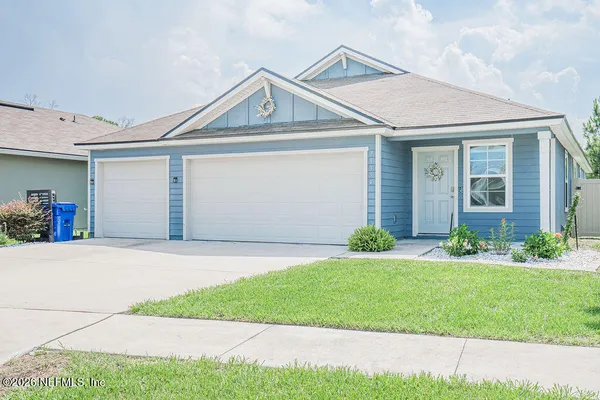a front view of a house with a yard and garage