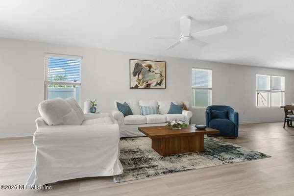 a living room with furniture and wooden floor