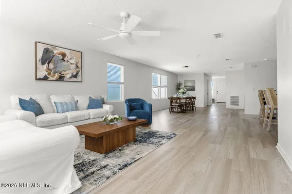 a living room with furniture and a wooden floor
