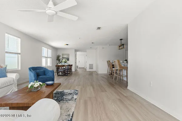 a view of a dining room with furniture and wooden floor