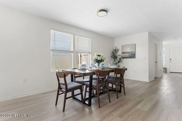 a view of a dining room with furniture and wooden floor