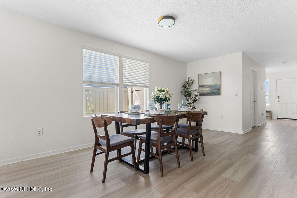 75394 Bridgewater Drive Yulee, FL 32097 - Photo 14 of 55 a view of a dining room with furniture and wooden floor