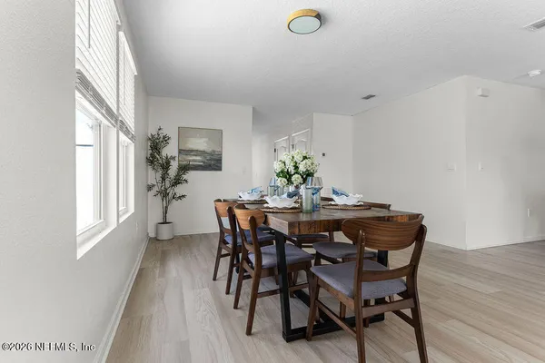 a dining room with furniture and wooden floor