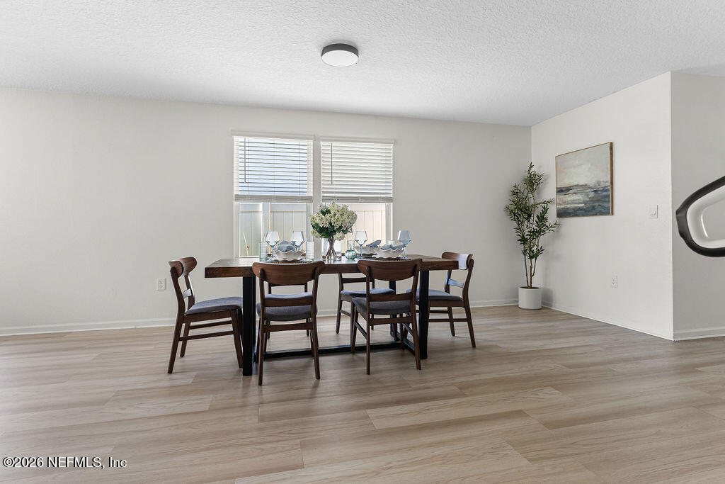 75394 Bridgewater Drive Yulee, FL 32097 - Photo 16 of 55 a dining room with furniture and wooden floor