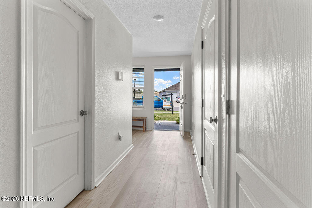 75394 Bridgewater Drive Yulee, FL 32097 - Photo 2 of 55 a view of a hallway with wooden floor and closet area