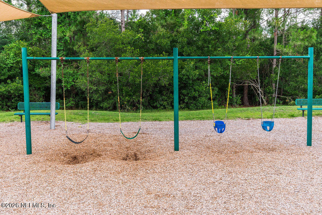 75394 Bridgewater Drive Yulee, FL 32097 - Photo 27 of 55 a view of a house with a backyard and a small yard