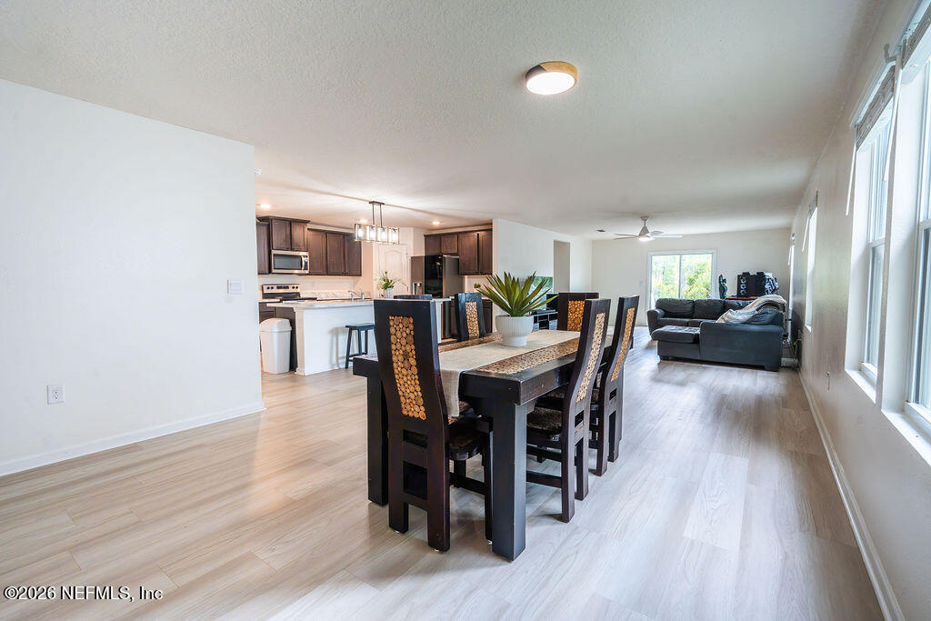 75394 Bridgewater Drive Yulee, FL 32097 - Photo 35 of 55 a view of a dining room with furniture and wooden floor