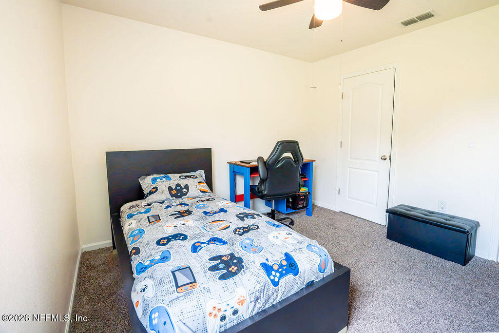 75394 Bridgewater Drive Yulee, FL 32097 - Photo 40 of 55 a bedroom with bed and a chandelier