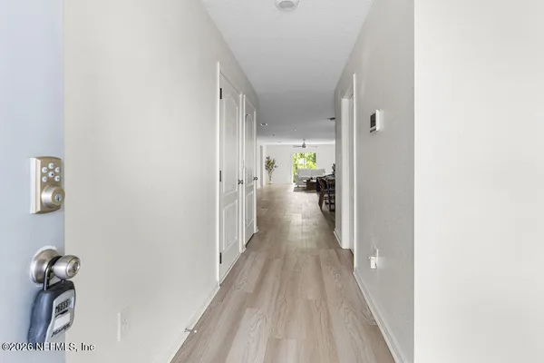 a view of a hallway with wooden floor
