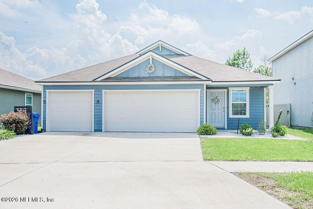 75394 Bridgewater Drive Yulee, FL 32097 - Photo 43 of 55 a front view of a house with a yard and garage
