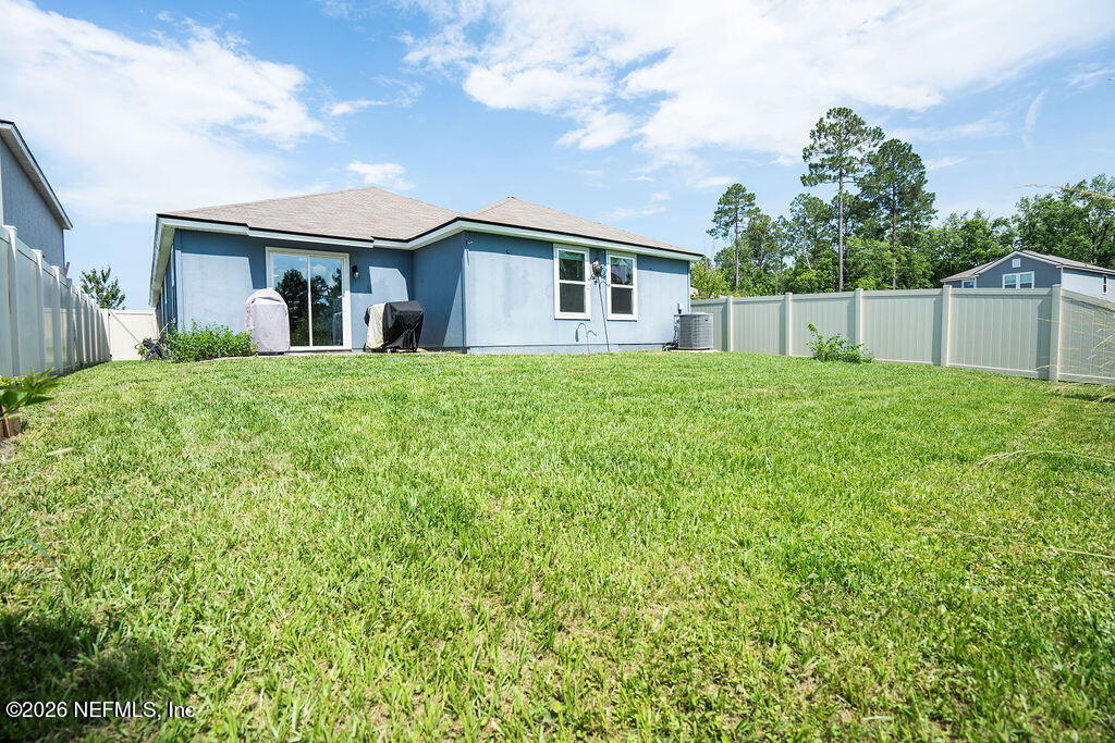 75394 Bridgewater Drive Yulee, FL 32097 - Photo 49 of 55 a view of house in front of a big yard with potted plants