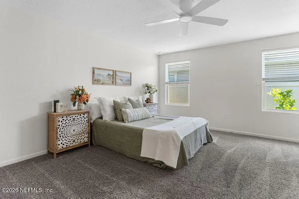 a bedroom with a bed and a night stand