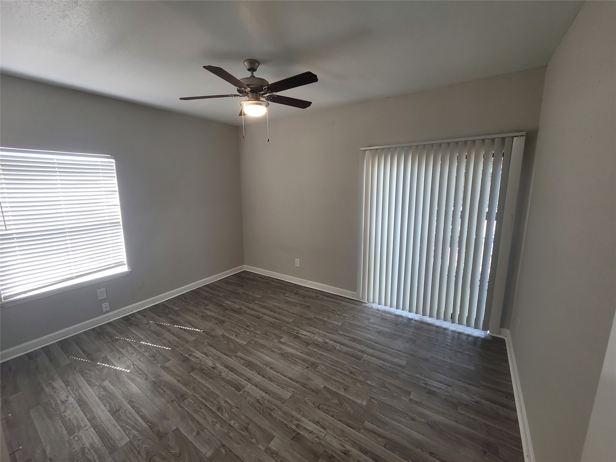 7250 West Greens Road, Unit 108 Houston, TX 77064 - Photo 7 of 9 a view of an empty room with wooden floor and a window