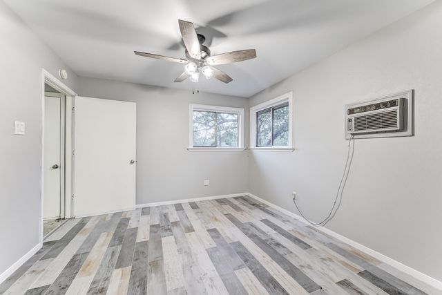 a view of room with window and ceiling fan