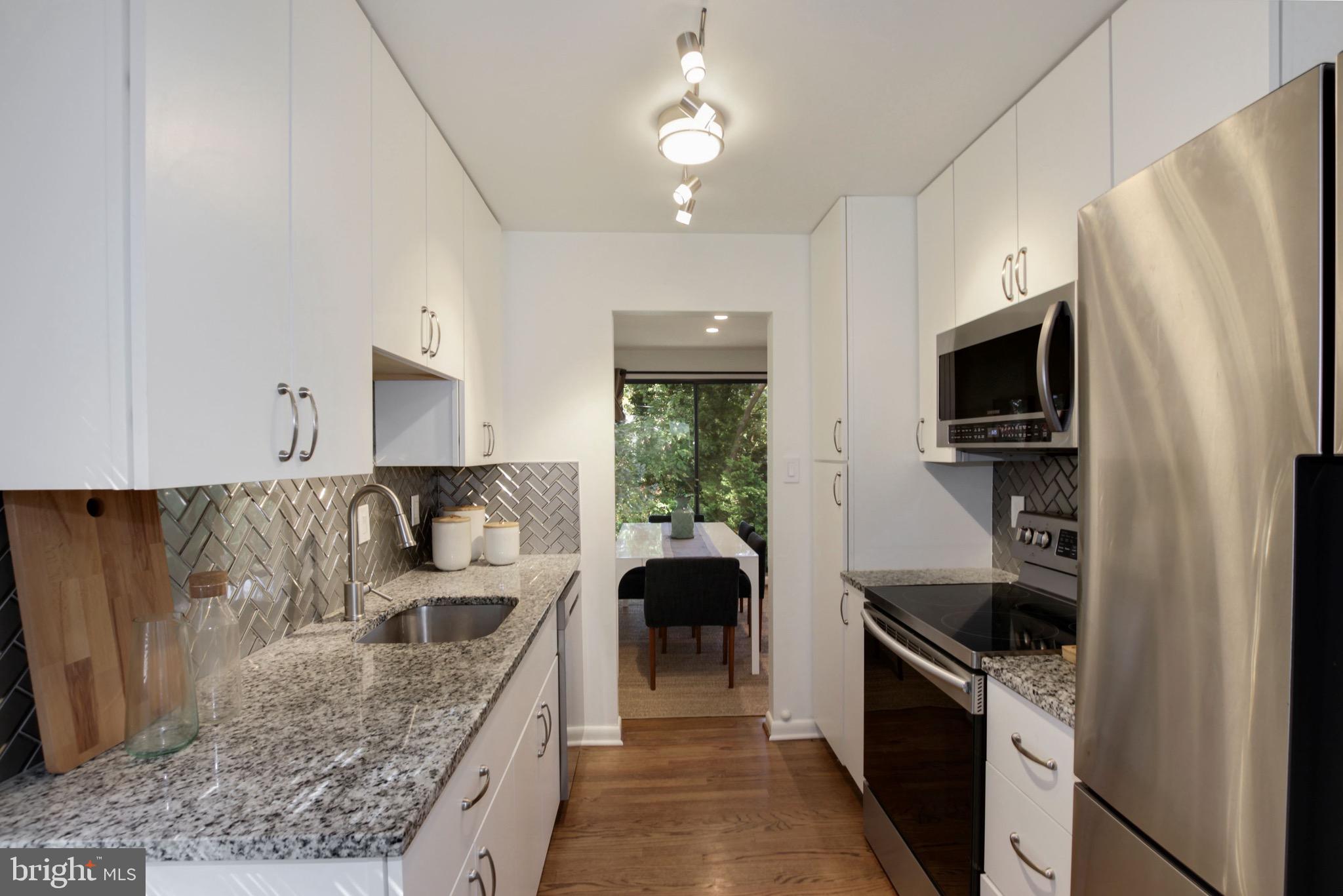 11207 Lombardy Road Silver Spring, MD 20901 - Photo 11 of 32 Kitchen with Glass Tile Backsplash