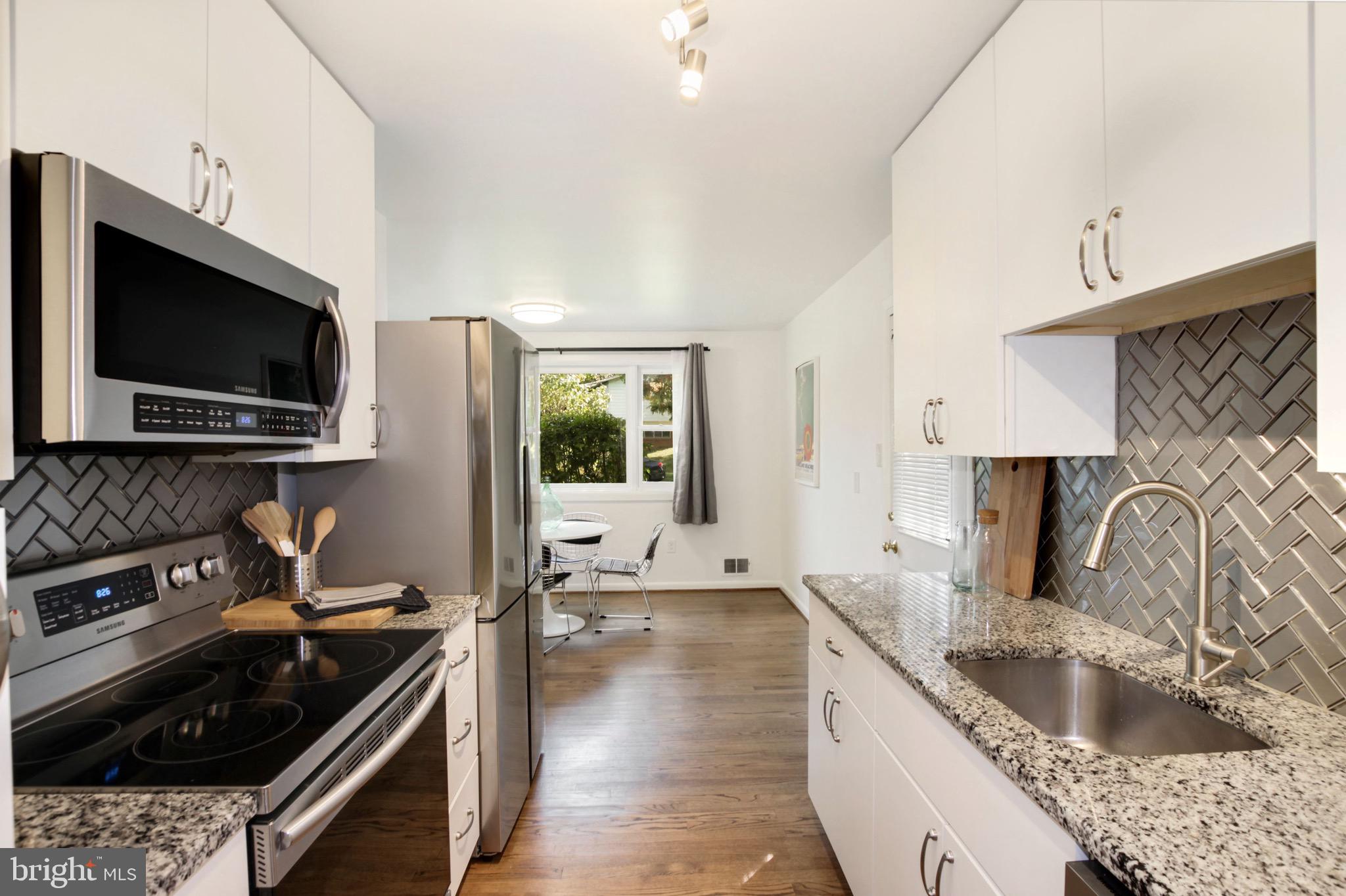11207 Lombardy Road Silver Spring, MD 20901 - Photo 12 of 32 Kitchen with Glass Tile Backsplash