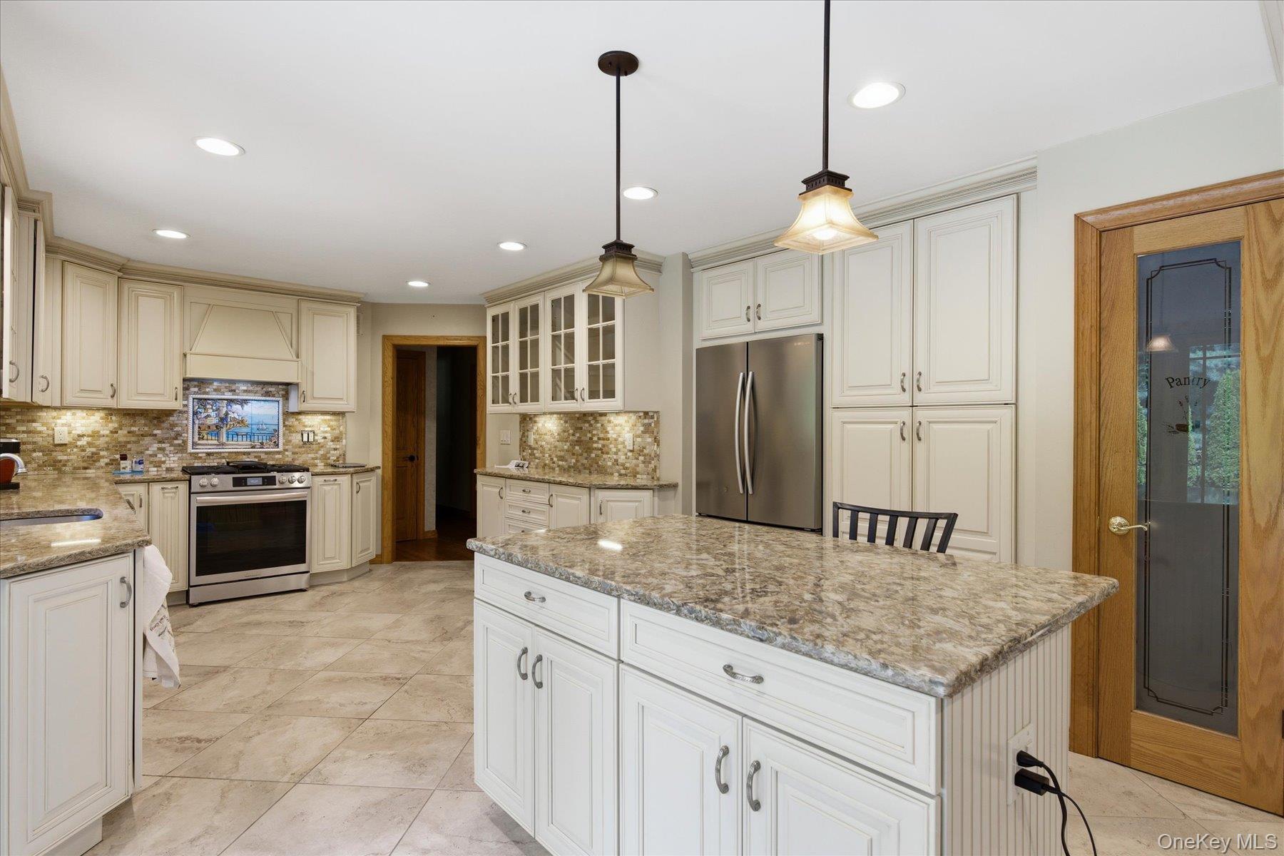 42 Cliff Road Port Jefferson, NY 11777 - Photo 11 of 22 a kitchen with stainless steel appliances granite countertop a refrigerator a sink and a stove