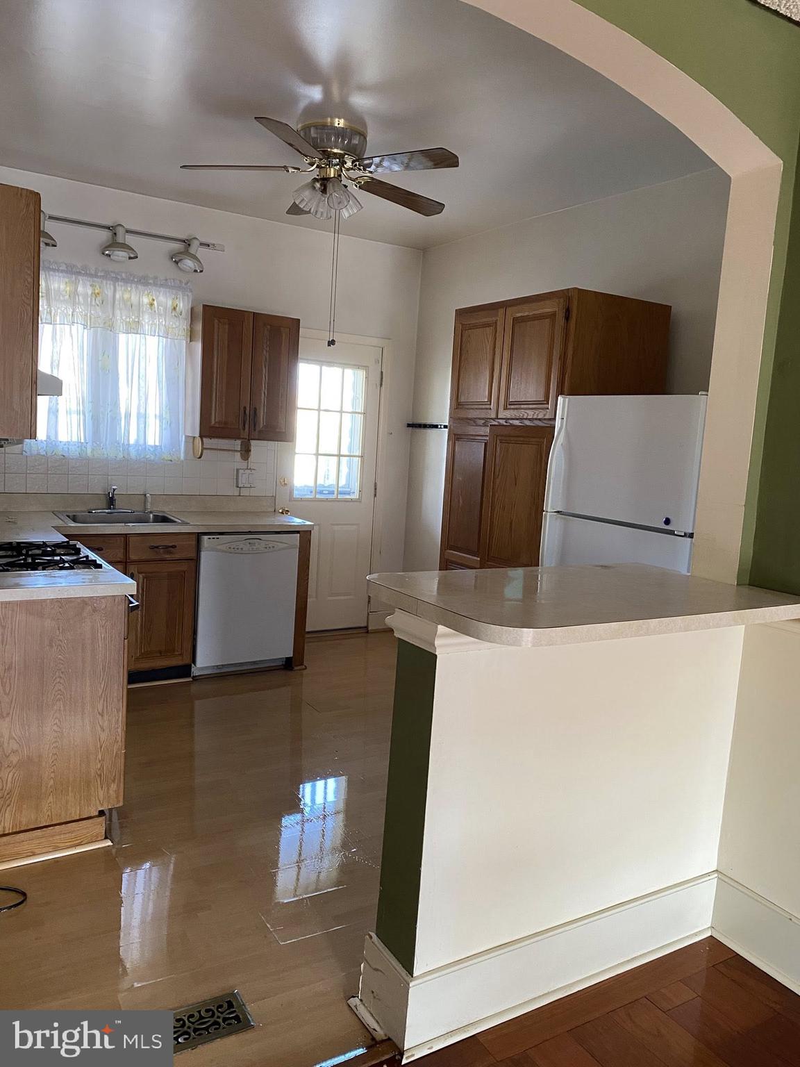 610 Rappolla Street Baltimore, MD 21224 - Photo 13 of 22 a living room with stainless steel appliances kitchen island granite countertop a refrigerator a stove a sink and a microwave