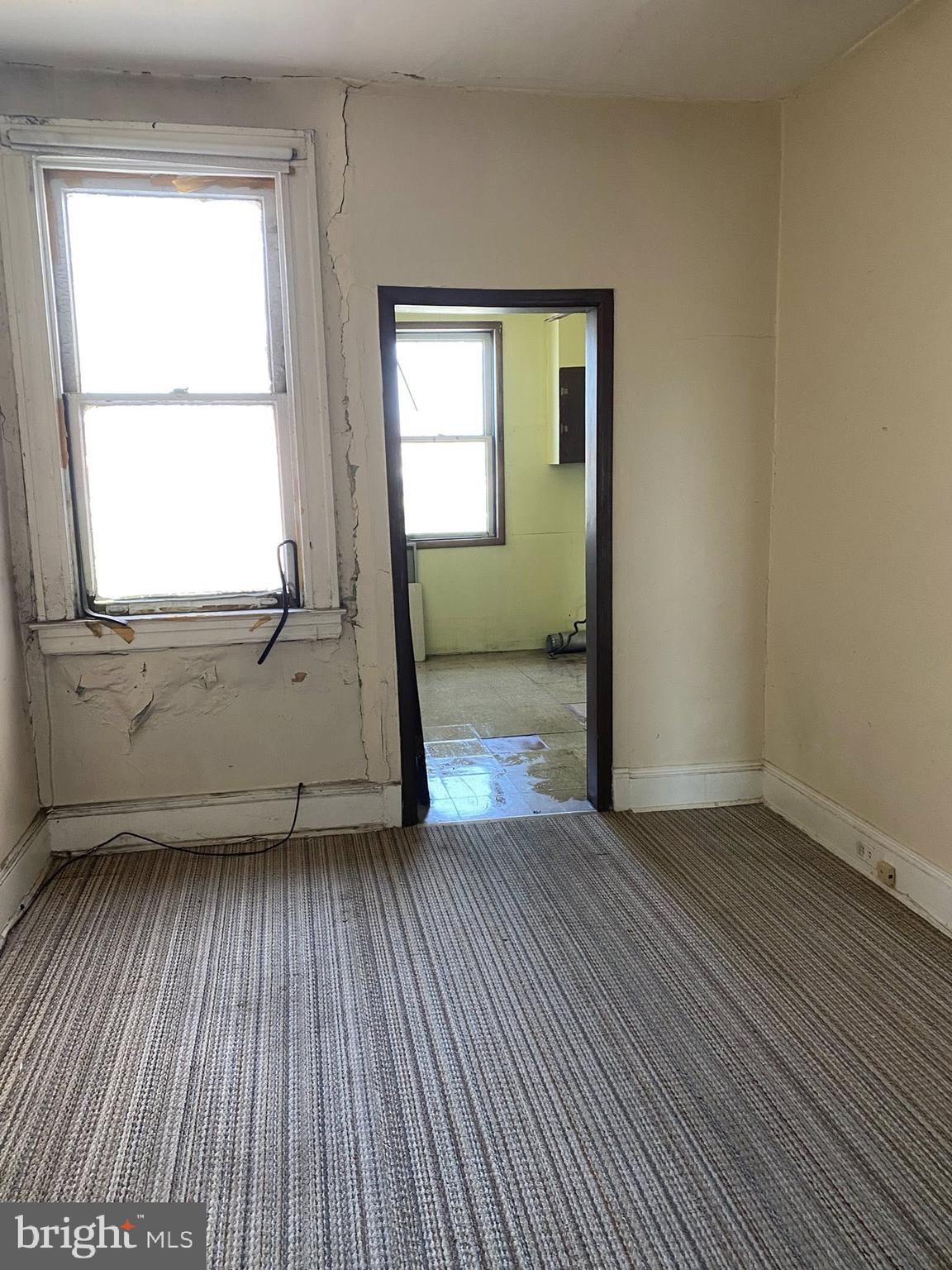 610 Rappolla Street Baltimore, MD 21224 - Photo 16 of 22 an empty room with wooden floor and windows
