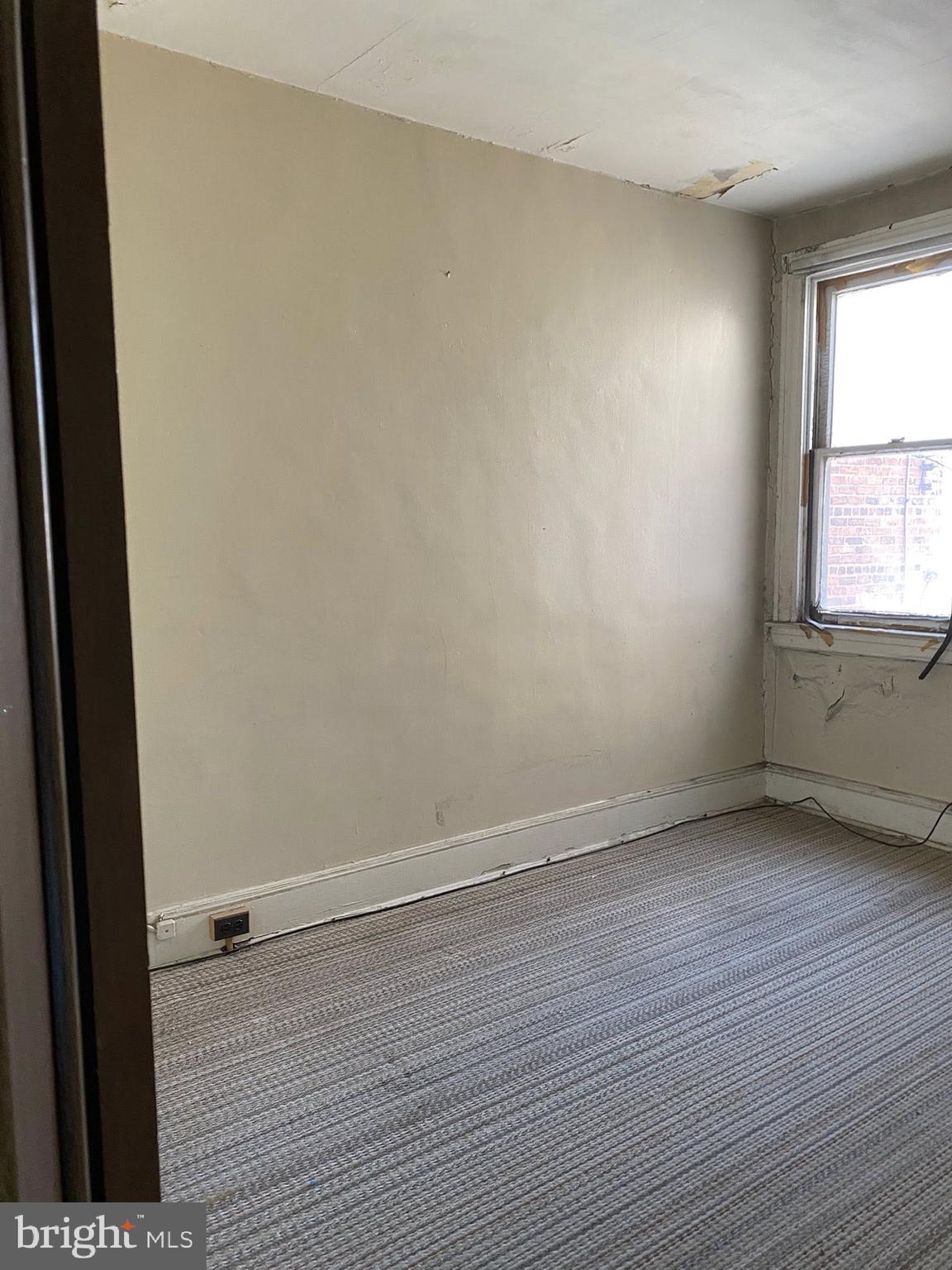 610 Rappolla Street Baltimore, MD 21224 - Photo 5 of 22 an empty room with wooden floor and windows