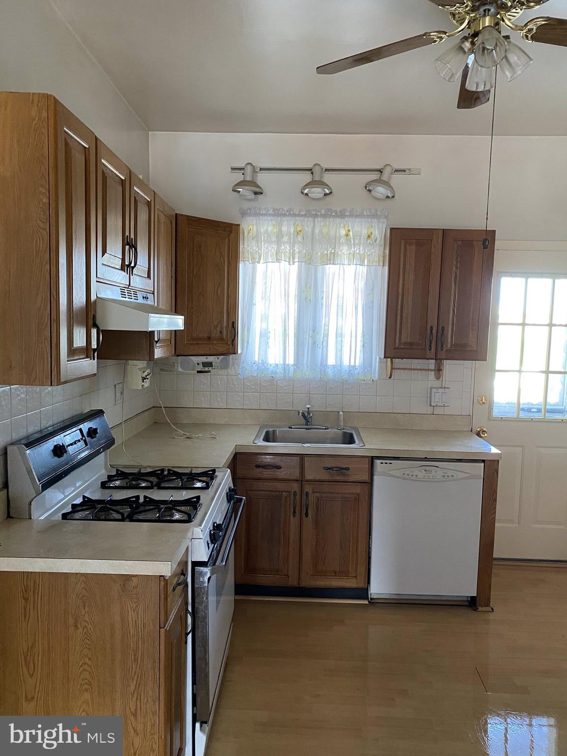 610 Rappolla Street Baltimore, MD 21224 - Photo 10 of 22 a kitchen with cabinets appliances a sink and a window
