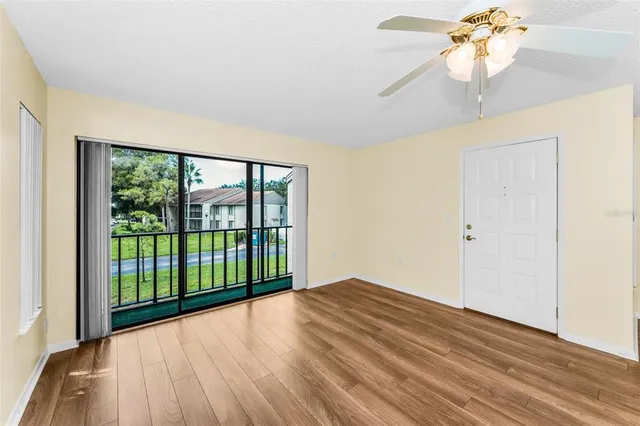 a view of a kitchen with wooden floor and a kitchen space