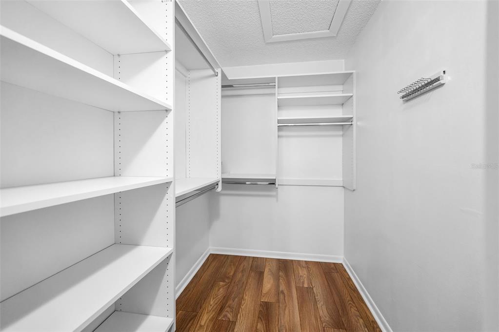 2687 Pine Ridge Way South, Unit F2 Palm Harbor, FL 34684 - Photo 32 of 62 a view of walk in closet with empty racks