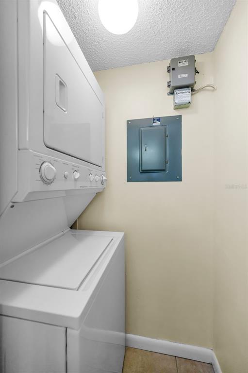 2687 Pine Ridge Way South, Unit F2 Palm Harbor, FL 34684 - Photo 35 of 62 a view of storage and utility room with washer and dryer