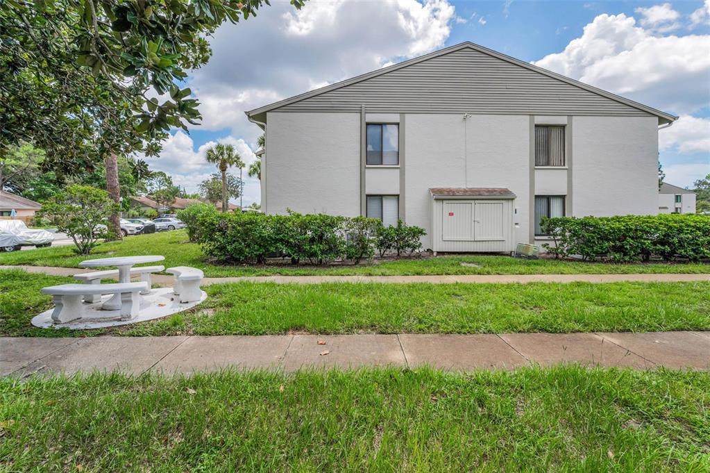 2687 Pine Ridge Way South, Unit F2 Palm Harbor, FL 34684 - Photo 38 of 62 a front view of a house with a yard