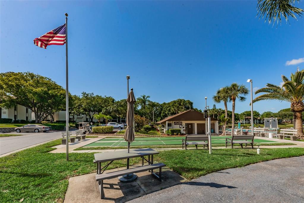 2687 Pine Ridge Way South, Unit F2 Palm Harbor, FL 34684 - Photo 54 of 62 a view of a park with swings and slides