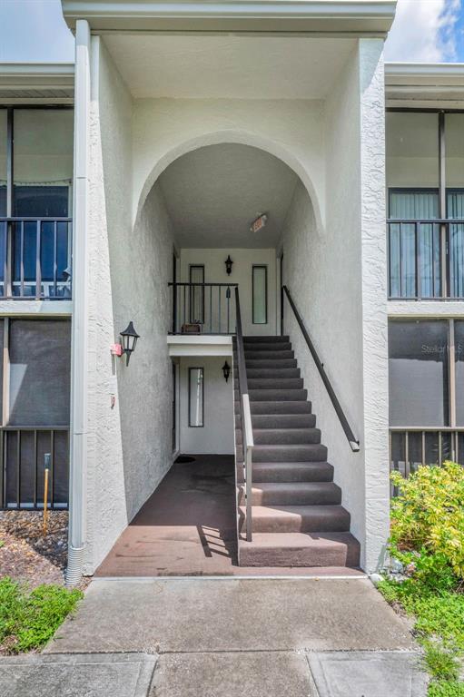 2687 Pine Ridge Way South, Unit F2 Palm Harbor, FL 34684 - Photo 9 of 62 a view of entryway and hall with wooden floor