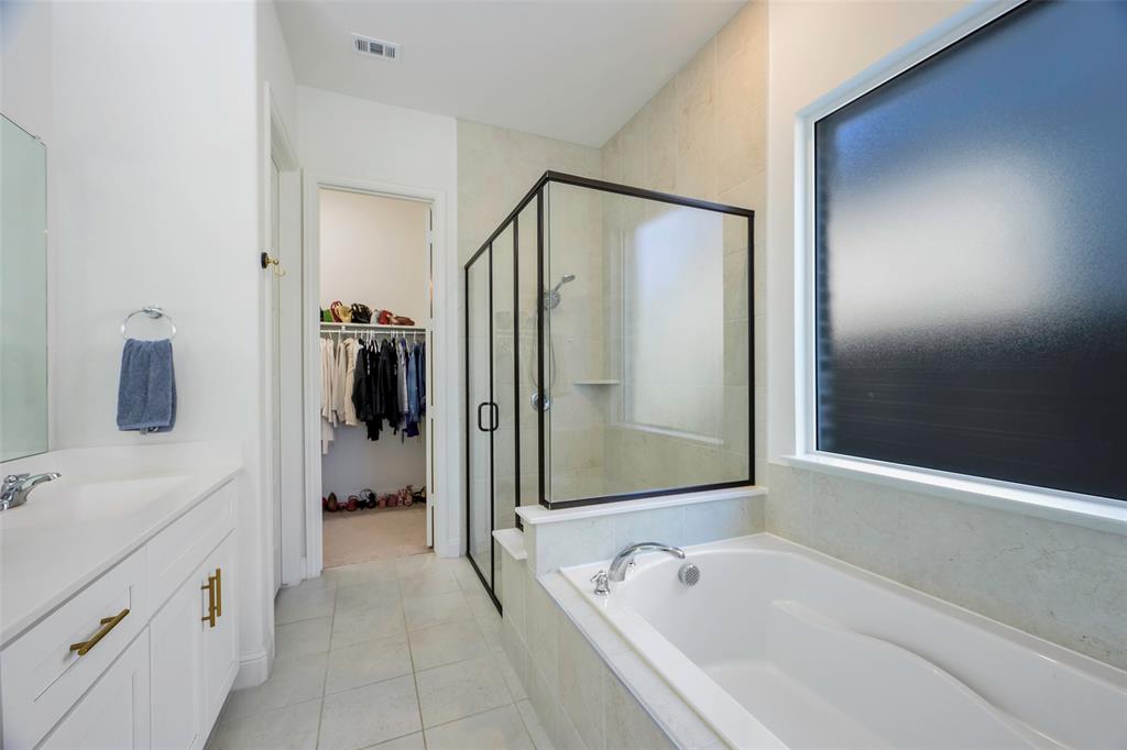 3603 Scotsman Road Sachse, TX 75048 - Photo 16 of 33 a bathroom with a tub a sink and mirror