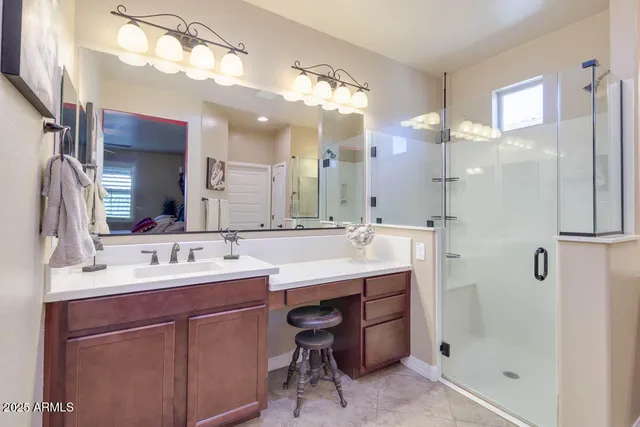 a bathroom with a double vanity sink mirror and shower